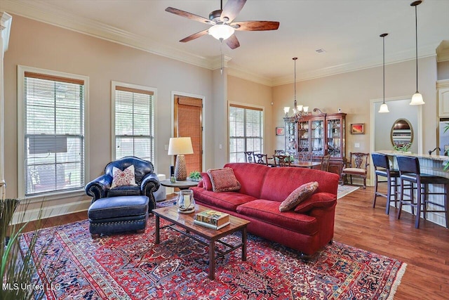 510 Belle Oak Pl, Brandon, MS 39042 - living room featuring a ceiling fan, a chandelier, wood finished floors, and ornamental molding