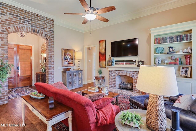 510 Belle Oak Pl, Brandon, MS 39042 - living area featuring wood finished floors, ceiling fan, a fireplace, ornamental molding, and arched walkways