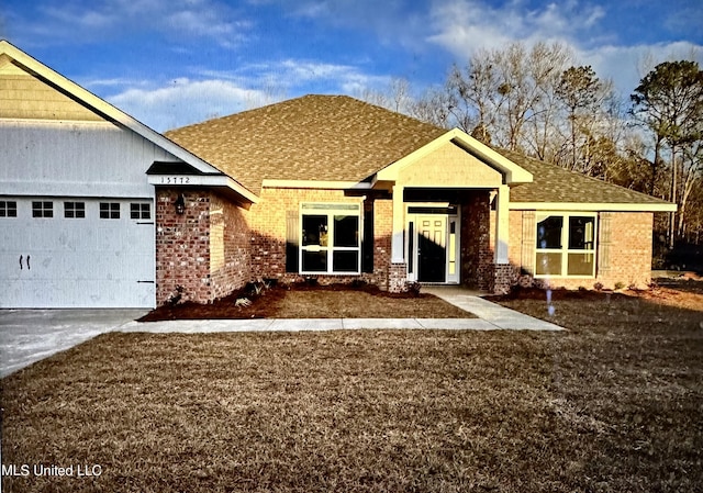 ranch-style home featuring concrete driveway, roof with shingles, a garage, and brick siding