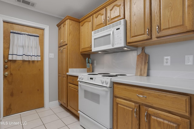 kitchen featuring white appliances, light tile patterned floors, visible vents, brown cabinetry, and light countertops