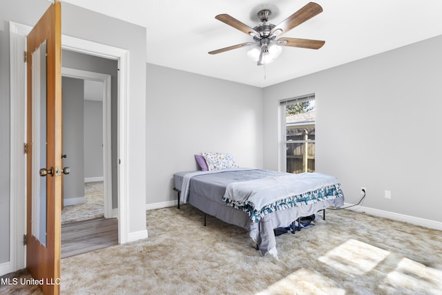 bedroom with carpet floors, a ceiling fan, and baseboards