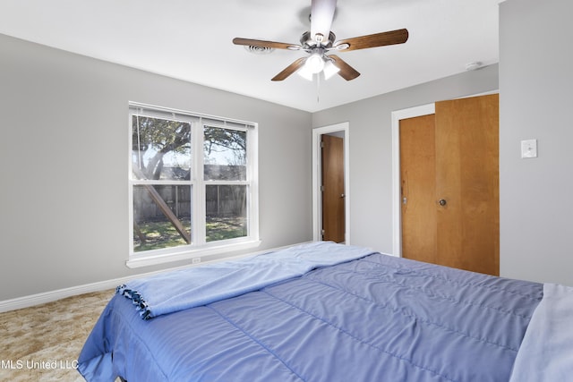 bedroom with ceiling fan and baseboards