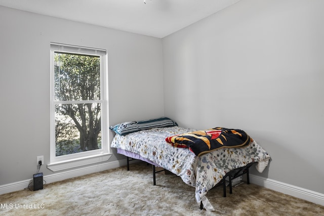 bedroom featuring carpet and baseboards