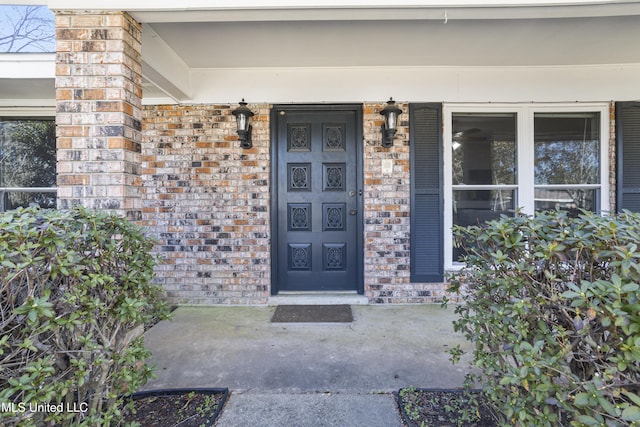 property entrance featuring brick siding