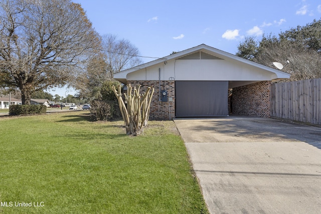 view of front of home with brick siding, driveway, a front lawn, and fence