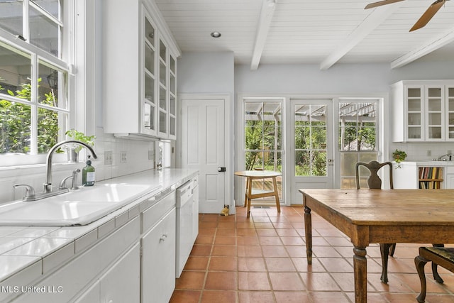 kitchen featuring sink, decorative backsplash, and white cabinets