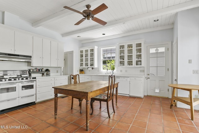 kitchen with light tile patterned floors, white appliances, beam ceiling, white cabinets, and decorative backsplash