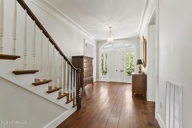 foyer entrance with dark wood-type flooring and ornamental molding