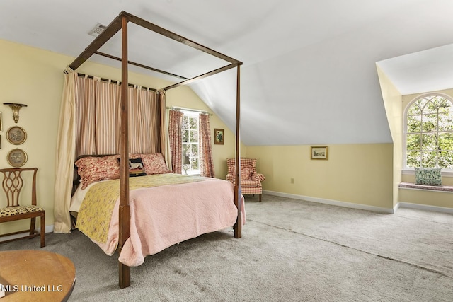 carpeted bedroom with vaulted ceiling and multiple windows