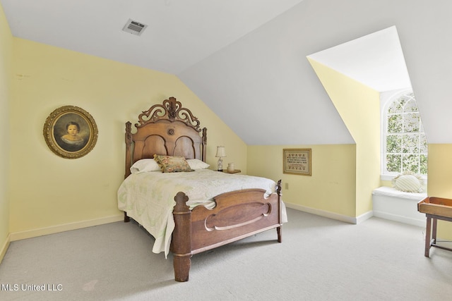 bedroom featuring lofted ceiling and light carpet