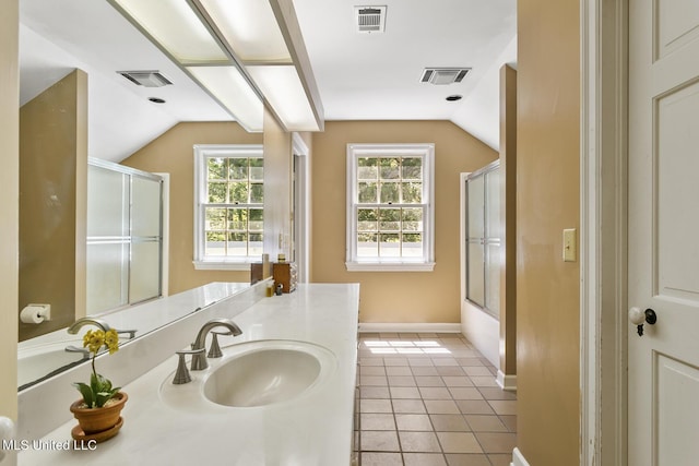 bathroom featuring vaulted ceiling, enclosed tub / shower combo, vanity, and tile patterned flooring