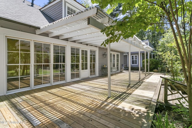 deck with french doors and a pergola