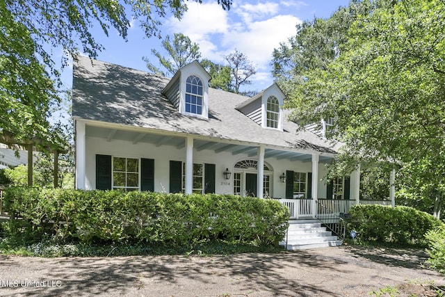 cape cod home featuring a porch