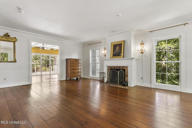 unfurnished living room with ornamental molding, a brick fireplace, dark hardwood / wood-style floors, and ceiling fan