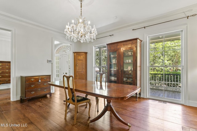 dining room featuring ornamental molding, dark hardwood / wood-style floors, and a wealth of natural light