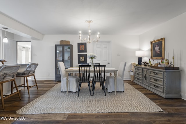 dining room featuring baseboards, dark wood finished floors, and a chandelier