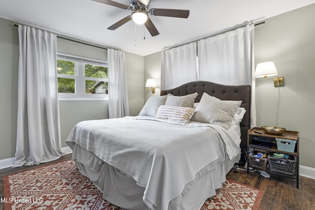bedroom featuring a ceiling fan, baseboards, and wood finished floors