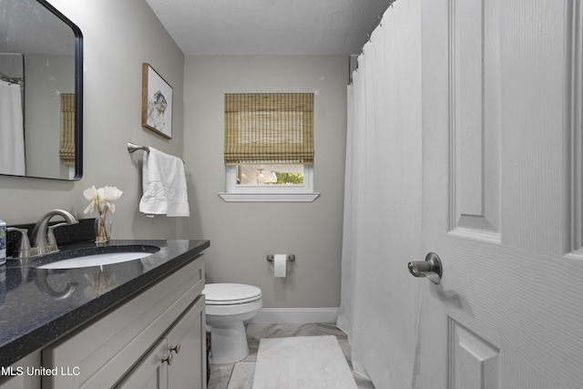 bathroom featuring vanity, baseboards, toilet, and marble finish floor