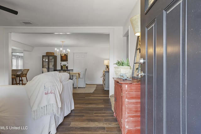 bedroom with visible vents, a chandelier, and dark wood-style floors