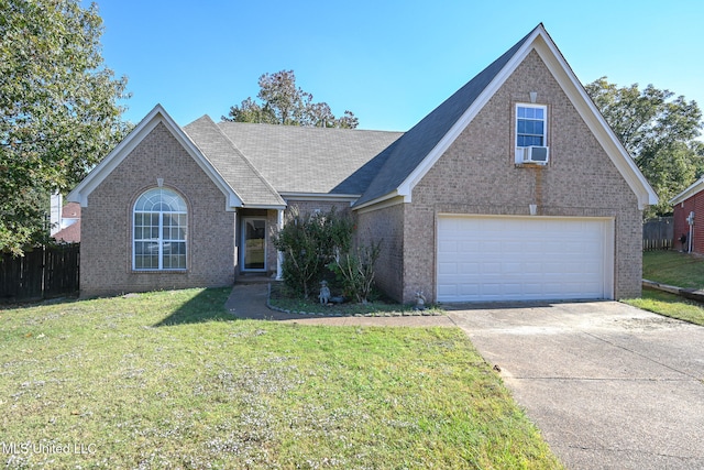 view of front of home with a front yard and a garage