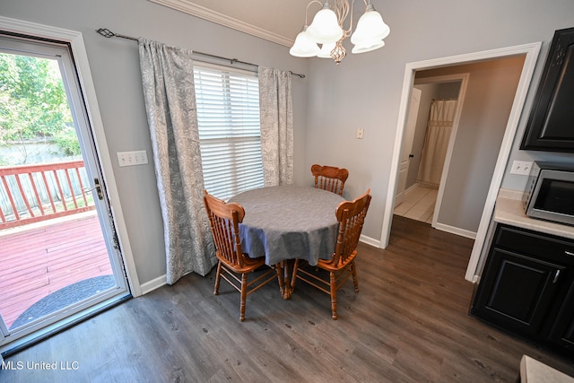 dining room with crown molding, a healthy amount of sunlight, and dark wood-type flooring