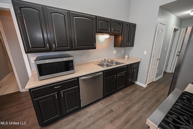6126 Rolling Oaks Cv, Olive Branch, MS 38654 - kitchen with a sink, light countertops, stainless steel appliances, and wood finished floors