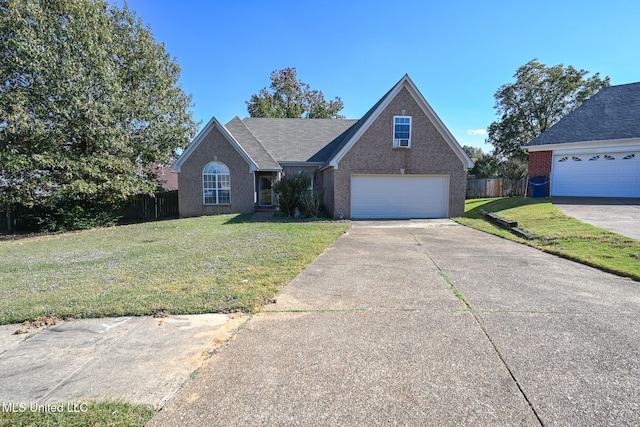 view of front of home with a front yard and a garage