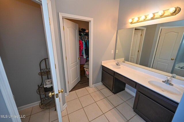 6126 Rolling Oaks Cv, Olive Branch, MS 38654 - bathroom with tile patterned flooring, a sink, baseboards, and double vanity