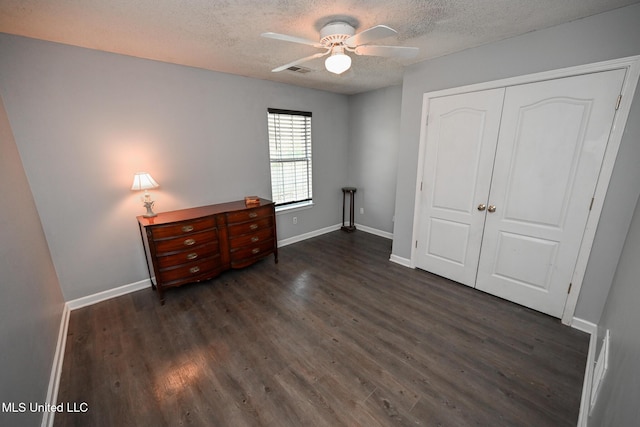 6126 Rolling Oaks Cv, Olive Branch, MS 38654 - bedroom featuring a closet, dark wood-style flooring, a textured ceiling, and visible vents