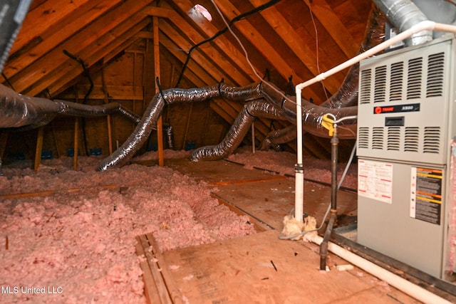 unfinished attic featuring heating unit