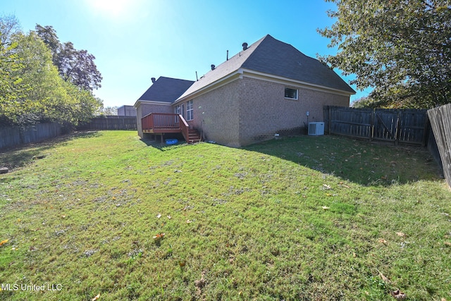 view of yard with a wooden deck and central AC unit