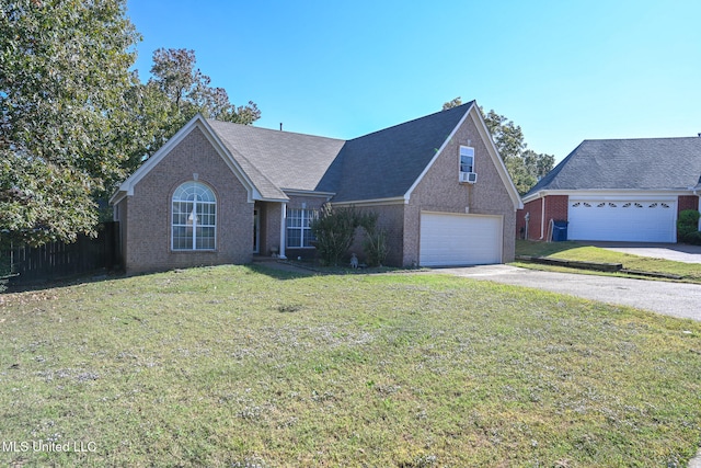 view of front of home with a garage and a front lawn