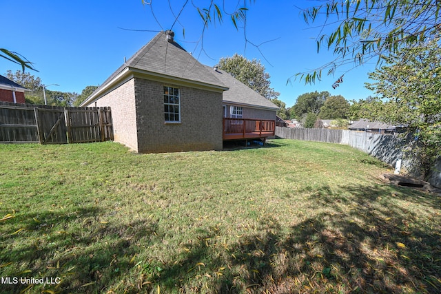 view of yard with a wooden deck