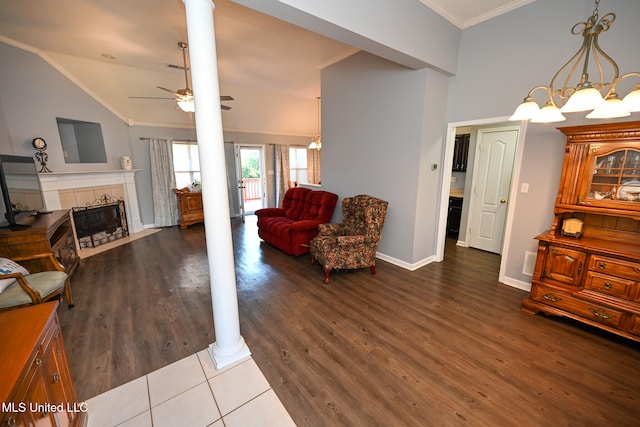 living room with lofted ceiling, ornamental molding, hardwood / wood-style flooring, and ornate columns