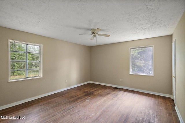 2862 Oak Forest Dr, Jackson, MS 39212 - empty room with dark wood finished floors, baseboards, a textured ceiling, and ceiling fan