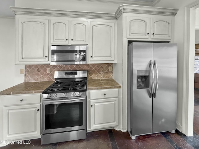 kitchen with stainless steel appliances, tasteful backsplash, and white cabinets