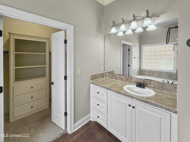 full bath with a washtub, a closet, and vanity