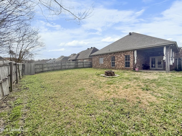 view of yard with an outdoor fire pit and a fenced backyard