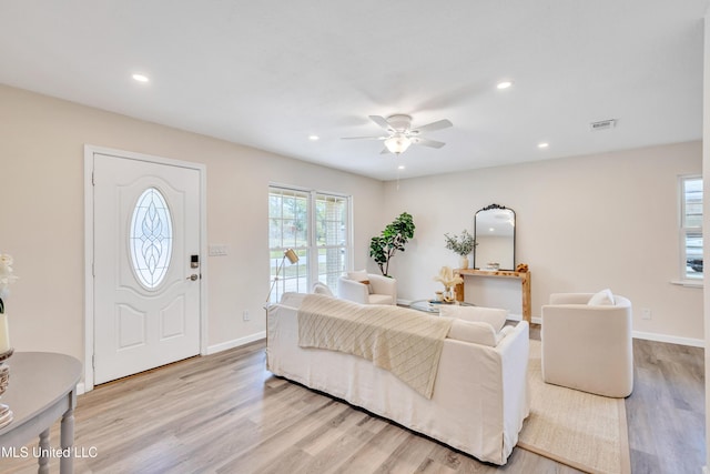 living room featuring ceiling fan and light wood-type flooring