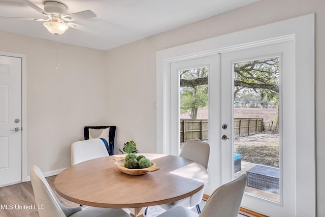 dining space featuring hardwood / wood-style flooring, ceiling fan, and french doors