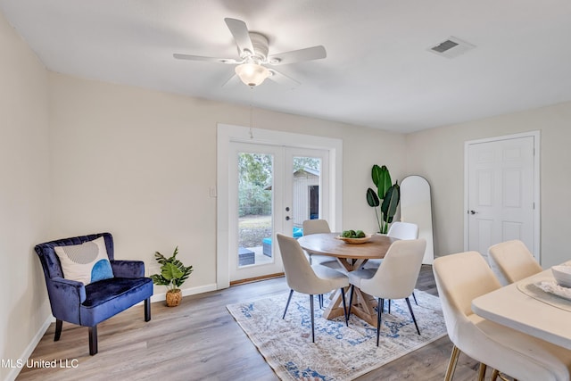 dining space featuring ceiling fan, light hardwood / wood-style flooring, and french doors