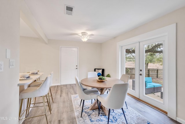 dining room with ceiling fan, light hardwood / wood-style flooring, and french doors