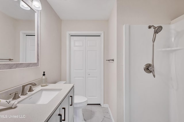 bathroom featuring a shower, toilet, and vanity