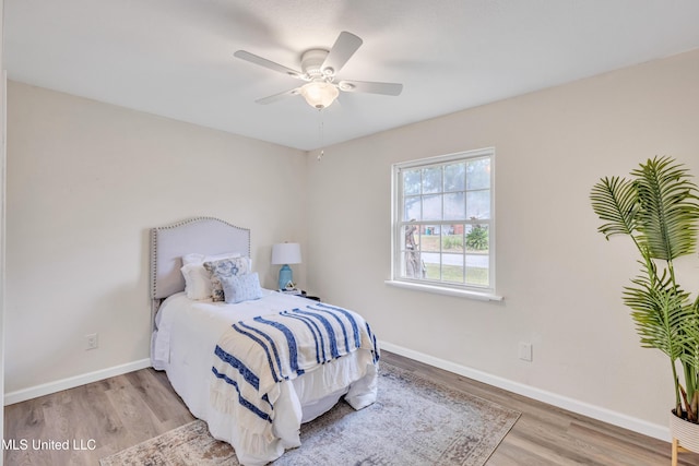 bedroom with ceiling fan and light wood-type flooring