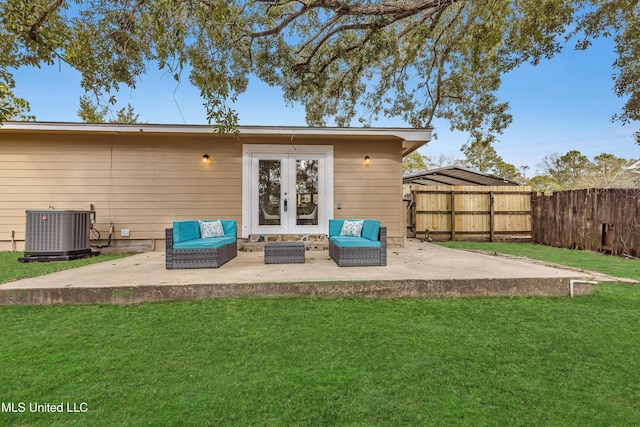 rear view of house featuring a patio area, central air condition unit, french doors, and a lawn