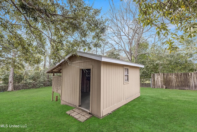 view of outbuilding featuring a yard