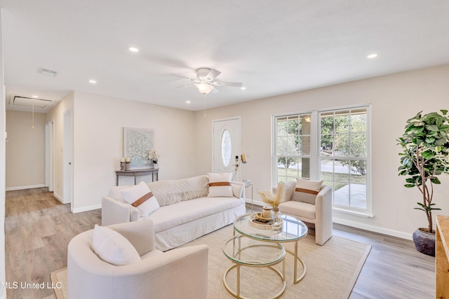 living room featuring ceiling fan and light hardwood / wood-style floors