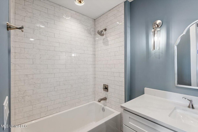 bathroom with vanity and tiled shower / bath