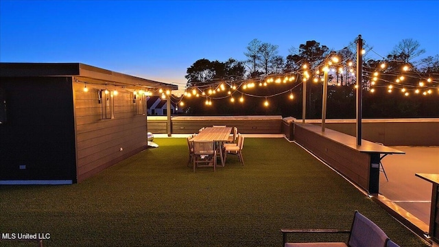 patio terrace at dusk with a lawn