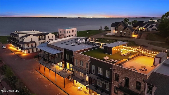 aerial view at dusk with a water view